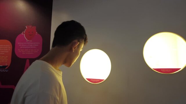 MALAYSIA, Damansara - December 9, 2025 A boy teenager viewing exhibition at National Science Museum