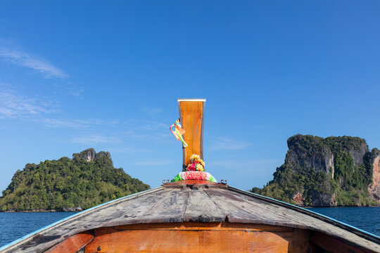 View of the prow of a traditional Thai longtail boat, heading towards the lagoon of Hong Island, in the Andaman sea near Krabi, southern Thailand. 
