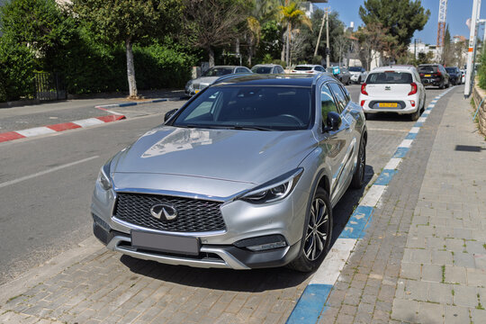 Infiniti crossover suv parked on city street daytime. 22 Feb 2026. Givatayim, Israel