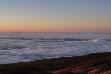 Fototapeta premium Sunset above clouds in Teide National Park Tenerife, volcanic mountains and sea of clouds landscape