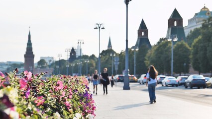 Fototapeta premium Moscow Kremlin towers and summer city street with people walking