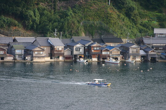 Panoramic view of Ine-no-Funaya, traditional wooden boathouses along the coast of Ine Bay, Kyoto, Japan.