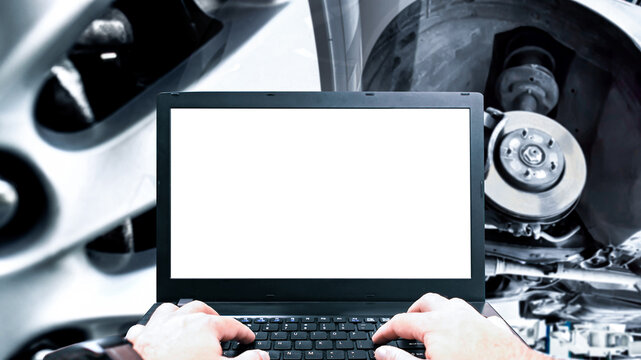 Digital Car Diagnostics, A technician uses a laptop with a blank white screen to run diagnostics on a vehicle's brake system and suspension in a modern workshop.
