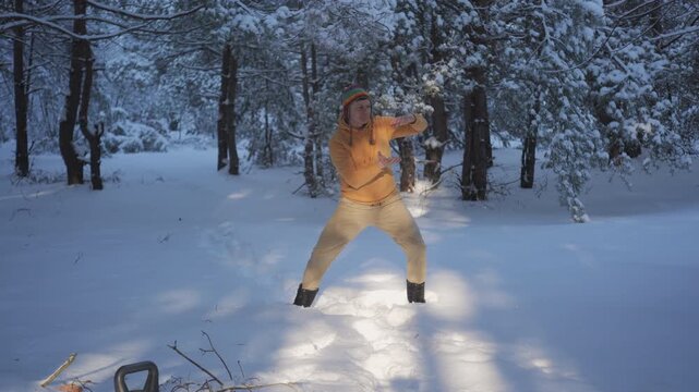 Man practicing breathing exercise in snowy forest landscape, calm winter activity improving focus balance and relaxation outdoors