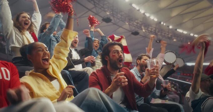 Diverse Fans in a Stadium Erupt With Cheer During a Championship Game Play. Team Competes in a Professional Sport Arena as a Decisive Goal Brings Applause, Smiles, Celebration.