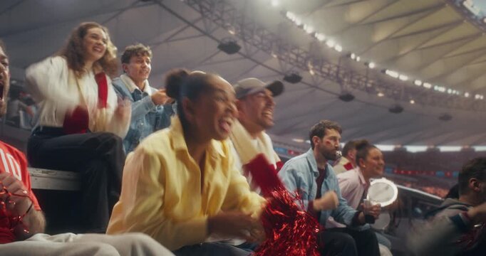 Diverse Fans in a Stadium Cheer as a Soccer Team Scores in a Championship Event, Celebrating a Goal With Applause and Raised Arms in a Professional Sport Arena During an International Match.