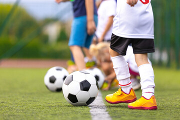 Youth Soccer Training Setup. Kids Standing with Football Balls on Outdoor Practice Field