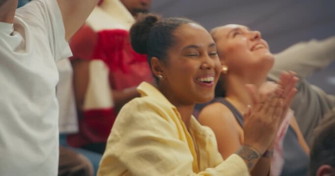 Diverse Happy Sports Fans Cheering in a Packed Stadium During a Professional League Match, Celebrating a Major International Cup Event From the Arena. Cinematic Zoom in Shot Focus on Fans Having Fun