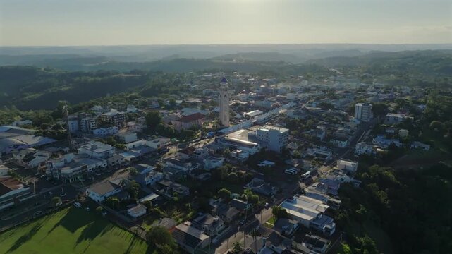 Ametista do Sul town center and church tower draw closer in a sunlit aerial approach, captured in D-Log with 10-bit color using a Hasselblad sensor.