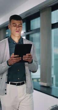 Walk, serious or man with tablet in hallway, review news article or proofreading story for online publication. Tech, journalism or editor with grammar check for draft, research or verify feature fact