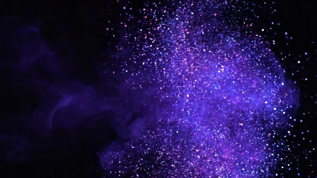Purple Ink Spreading in Water with Glittering Particles on Black Background.