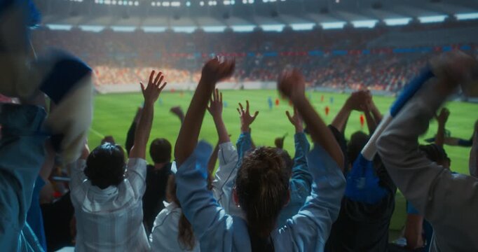 Back Multicultural Soccer Supporters Celebrate in a Packed Stadium, Raising Blue and White Scarves, Applauding with Hands During an World Championship Match Event
