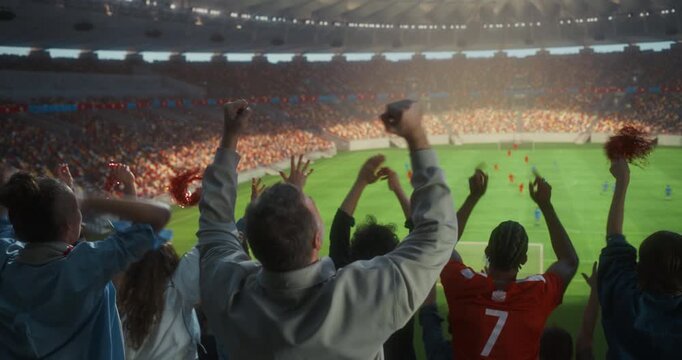 Back View of Diverse Soccer Supporters Celebrating in a Packed Stadium, Raising Arms, Clapping and Waving Victory Props as a Professional International Championship Match Unfolds Field