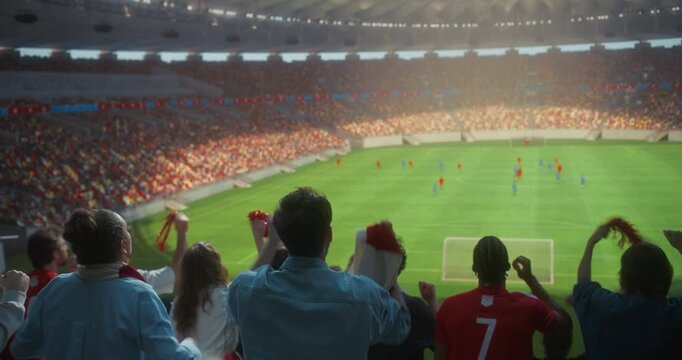 Back View of Diverse Soccer Supporters Celebrating in a Packed Stadium, Waving Scarves and Victory Props, Clapping and Raising Arms as a Professional International Championship Match Unfolds Field