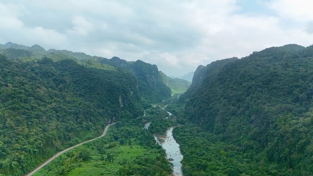 Bo Trach, Quang Binh (Quang Ngai), Vietnam: 4K aerial drone footage of Phong Nha &ndash; Ke Bang National Park, UNESCO karst mountains, limestone cliffs, rive, tropical forest, misty valley landscape.