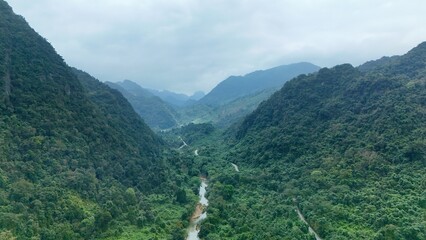 Bo Trach, Quang Binh (Quang Ngai), Vietnam: 4K aerial drone footage of Phong Nha – Ke Bang National Park, UNESCO karst mountains, limestone cliffs, rive, tropical forest, misty valley landscape. © Thomas