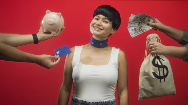 Woman smiling as hands offer cash, creditcard, piggybank and a moneybag in a studio; financial optimism.