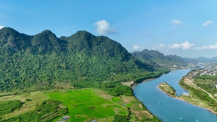 Phong Nha – Ke Bang National Park, Bo Trach, Quang Binh, Central Vietnam – 4K aerial footage of UNESCO Heritage site with Son River, limestone karst mountains, rice fields, tropical forest and cave. © Thomas
