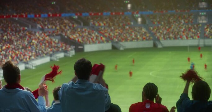 Rear View of Diverse Soccer Supporters in a Full Stadium Cheering a Professional International Championship Match, Waving Scarves and Victory Props, Clapping Raising Arms as Game Continues on Field.
