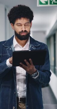 Walk, review or man with tablet in hallway, news article evaluation or proofreading story for publication. Tech, journalism or editor with grammar check for feature draft, send feedback or approval