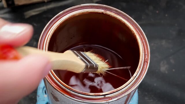 Paint Brush Resting on Open Can of Wood Stain Closeup Detail