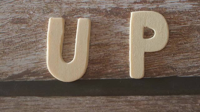 Wooden letters written up from bottom to top zoom