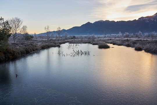 Scenic landscape view of wintry bog lake and mountains, Kendlmuehlfilzen, Bavaria, Germany
