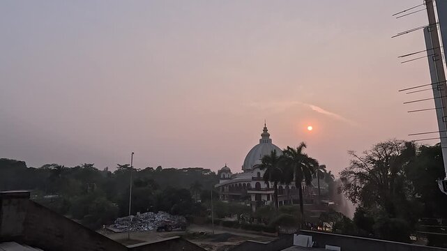  Sunset behind the Hare Krishna temple in Mayapur, West Bengal. The skyline of the town during sunset.