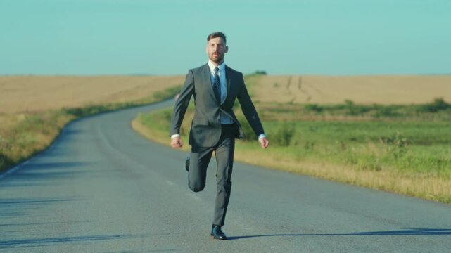 Man runs triumphantly, Man in business attire enthusiastically rushes across scenic rural highway with jacket flying