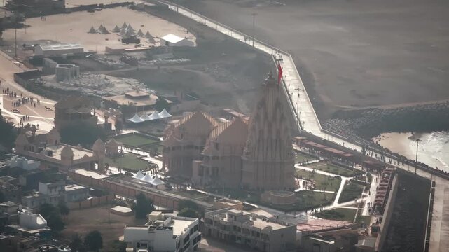 Aerial view of Somnath Temple in Gujarat, India, showcasing the grand coastal shrine dedicated to Lord Shiva. The image highlights the temple&rsquo;s majestic architecture and the Arabian Sea.
