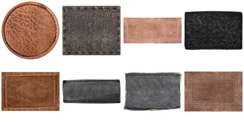Fototapeta premium Collection of diverse genuine leather labels and patches in various earthy tones and textures, featuring stitched edges.