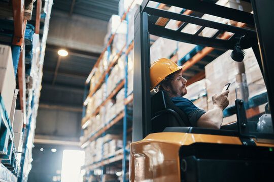 Forklift operator using smartphone for inventory in warehouse