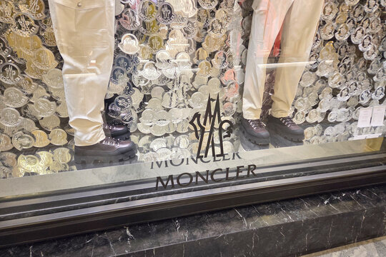 Bologna, Italy, January 2, 2026: Fashion Display with Moncler Clothing and Footwear in Stylish Storefront
