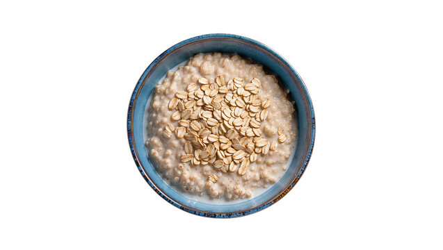 Creamy oatmeal porridge in a blue ceramic bowl topped with toasted pumpkin seeds, isolated on transparent background for healthy breakfast concepts