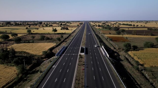 Aerial view of the Delhi&ndash;Mumbai Expressway, showcasing a modern multi-lane highway cutting through the landscape. The image highlights India&rsquo;s advanced infrastructure, smooth road network.