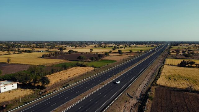 Aerial view of the Delhi&ndash;Mumbai Expressway, showcasing a modern multi-lane highway cutting through the landscape. The image highlights India&rsquo;s advanced infrastructure, smooth road network.