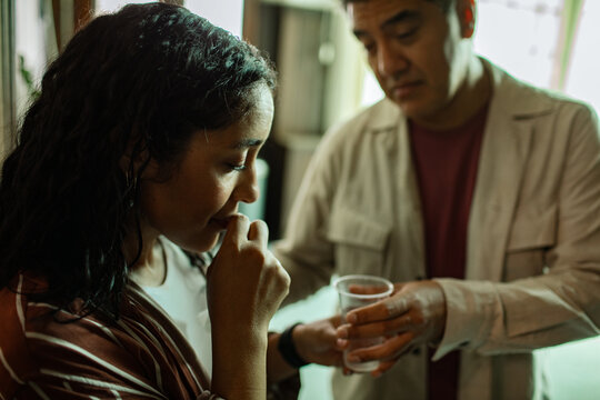 Counselor helping anxious woman during group therapy meeting indoors