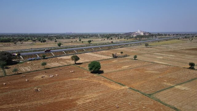 Aerial view of the Delhi&ndash;Mumbai Expressway, showcasing a modern multi-lane highway cutting through the landscape. The image highlights India&rsquo;s advanced infrastructure, smooth road network.