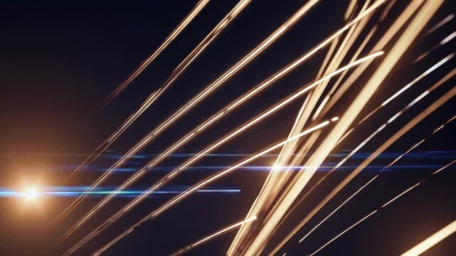 Glowing gold light lines slice diagonally across a dark background; reflections and soft halos amplify motion, energy, and a futuristic, cinematic abstraction with long trails and glow