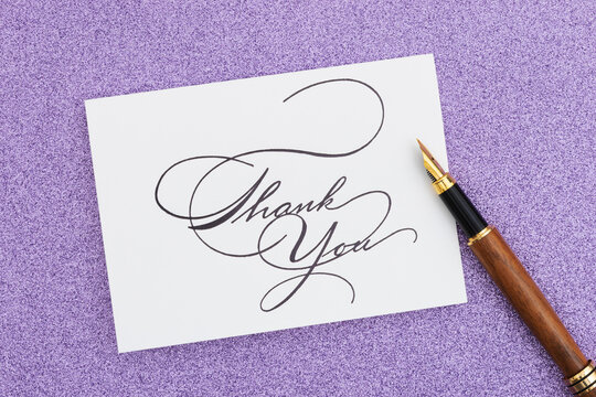 Thank you card with pen on purple