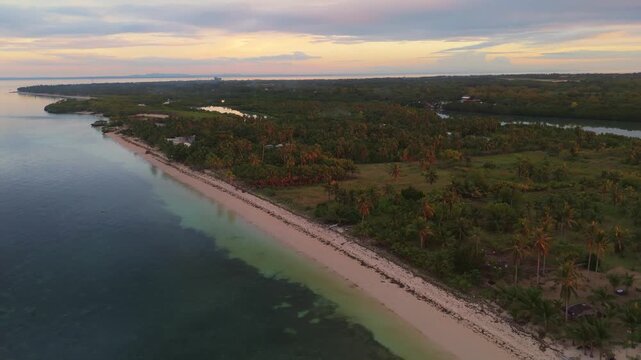 Aerial drone view of the tropical coastline of Bantayan Island, Cebu, Philippines. Stunning white sand beach and turquoise ocean water at sunset