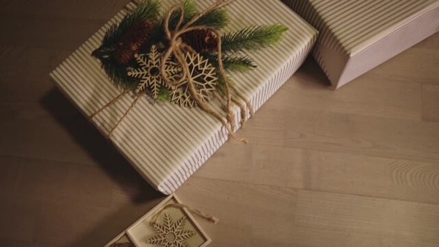 Holiday Gift Present Boxes Wrapped In Simple Kraft Paper And Decorated With Natural Christmas Elements. High Angle Tracking Shot
