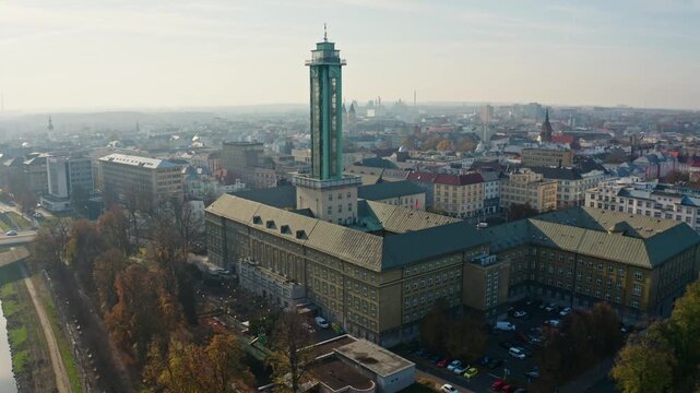 Down drone shot around ostrava city hall tower in summer
