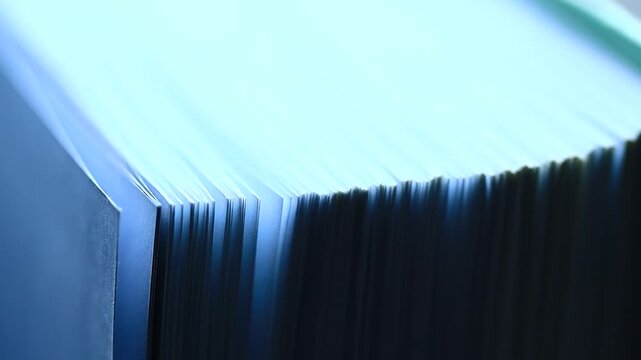 A stack of blue folders sitting on a table, great for office or home use