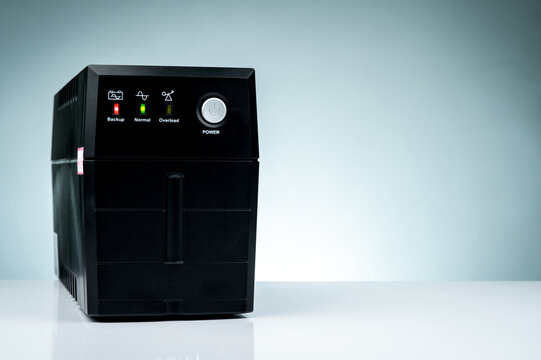 Uninterruptible power supply isolated on white background. Backup Power UPS with battery. UPS with stabilizer for home PC. Equipment for computer system at office for security. Power protection.