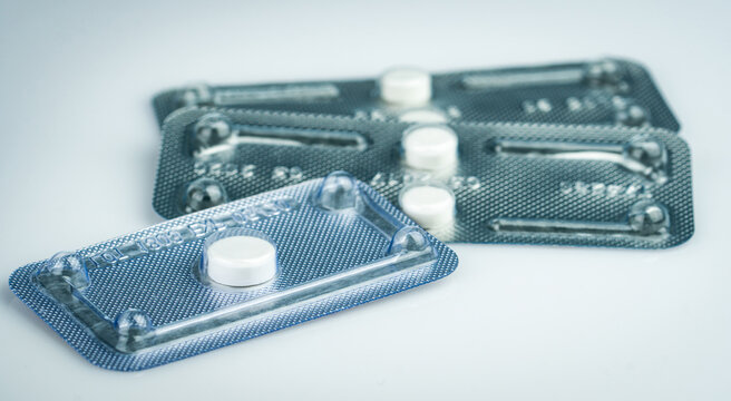 Emergency contraceptive pills in blister pack on blurred background of morning after pills. Drug cause of ectopic pregnancy. Emergency contraception for prevent pregnancy. World Contraception Day.
