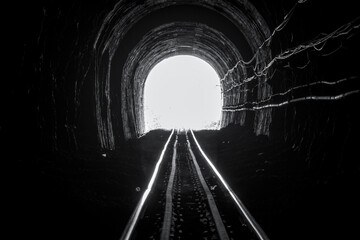 Train tunnel. Old railway in cave. Hope of life in the end of the way. Railroad of locomotive train in Thailand. Old architecture. Railway tunnel built in 1914. Travel and hope at the destination. © Fahroni