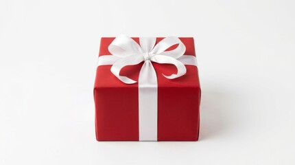 Obraz premium A vibrant red gift box with a crisp white ribbon bow is presented against a clean, bright white background, evoking a festive and celebratory mood.