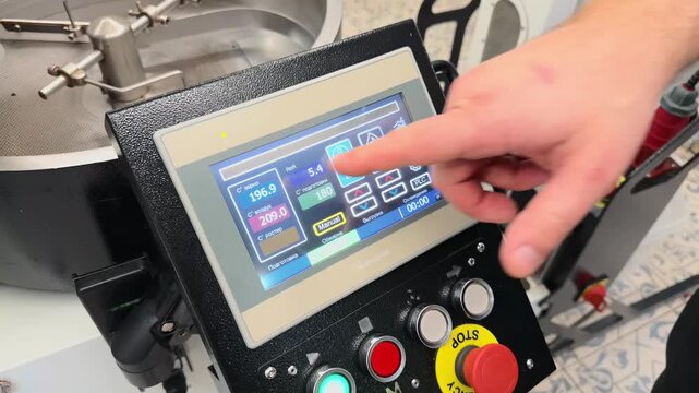 Professional Coffee Roaster Operator Hand Adjusting Digital Touchscreen Interface Displaying Real Time Roast Profile Graphs and Temperature Metrics in Specialty Roastery Detailed Close Up Zoom Shot