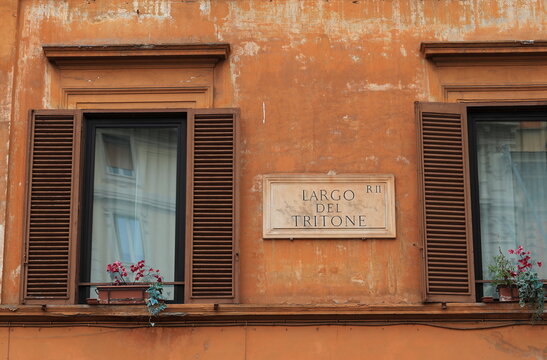 Brown Building Facade With Windows and Largo del Tritone Street Sign in Rome, Italy